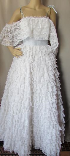 a mannequin wearing a white dress with ruffles