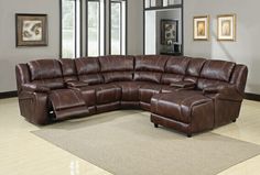 a living room with a sectional couch and reclining chair in the middle of it