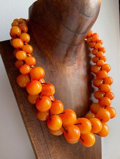 Make a statement with this Mango Orange multi beaded Necklace. Made with various sized round beads threaded on black cotton.  Fastens with metal hook. Measures: 45 cm. HANDMADE & FAIRTRADE Items posted to addresses within the UK will be sent Royal Mail 1st Class UK Standard. Overseas by Royal Mail International Tracked and Signed. Luxury Orange Beaded Necklace With Gemstones, Hand-strung Orange Beaded Necklace, Luxury Orange Hand-strung Beaded Necklace, Luxury Traditional Orange Beaded Necklace, Adjustable Beaded Necklaces With Round Beads, Adjustable Amber Beaded Necklace With Large Beads, Amber Beaded Necklaces With Colorful Beads, Orange Polished Beads Necklace, Orange Large Beads