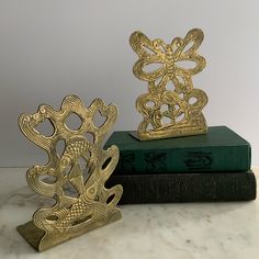 two bookends sitting on top of books next to each other