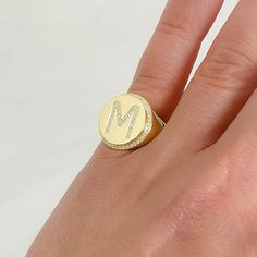 This round shaped signet style ring is composed of 14K solid gold & finished with a pavé diamond initial letter. The gemstones used in this design are of genuine GVs1 quality natural real diamonds. Ring Dimensions: Raised Round Surface: approximately 14mm (diameter) Signet Surface Height from Inner Band Thickness: approximately 4mm Inner Band Ring Thickness: approximately 4.5mm Metal Finish: High Shine Polish This design is available in Rose, White and Yellow 14K Gold Please note that this i Luxury Yellow Signet Ring, Chunky Gold Signet Rings, Personalized Oval Diamond Initial Ring, Luxury Rose Gold Initial Ring, Luxury Personalized Rose Gold Initial Ring, Personalized Luxury Rose Gold Initial Ring, Fine Jewelry Monogram Initial Ring, Customizable Yellow Gold Round Signet Ring, Customizable Yellow Gold Signet Ring