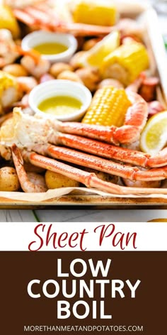 a sheet pan filled with lobster, corn and potatoes