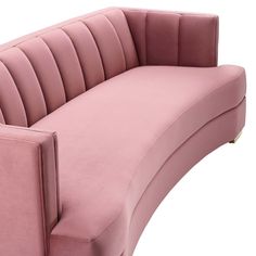 a pink couch sitting on top of a white floor