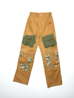 Upcycled cargo pants with camouflage patches Measurements Measurements taken by seller with item in hand. Measured with garment laid flat. Waist 12.99 in 33 cm Hip 17.72 in 45 cm Inseam / Length 29.13 in 74 cm Leg Opening 9.06 in 23 cm Front Rise 13.39 in 34 cm Military Style Cargo Jeans With Multiple Pockets For Streetwear, Military Style Cargo Jeans With Patch Pockets For Streetwear, Military Style Cargo Pants With Multiple Pockets For Streetwear, Khaki Streetwear Pants With Multiple Pockets, Military Style Khaki Parachute Pants With Patch Pockets, Khaki Techwear Cargo Jeans With Pockets, Khaki Pants With Multiple Pockets For Streetwear, Camouflage Cotton Cargo Parachute Pants, Camouflage Cargo Jeans With Patch Pockets For Streetwear