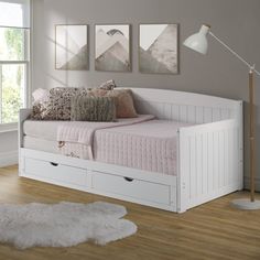 a white daybed with two drawers underneath it in a room next to a window