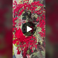 a christmas wreath with red berries and green leaves