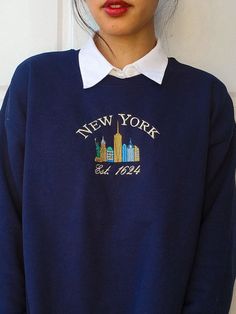 This vintage inspired crewneck features an embroidered design of New York's skyline. Whether it's for yourself or a gift, get cozy, comfy, and stylish with this embroidered sweatshirt. Crewnecks are embroidered with a one-of-a-kind design inspired by places, experiences, and adventures! ⭐  PRODUCT DETAILS * Unisex Sizing * Sweatshirts: 50% cotton, 50% polyester * T-Shirts: 100% cotton * Size up 1-2 sizes for a looser comfy fit ⭐  CARE INSTRUCTIONS Wash with cold water. Hang drying is recommended Luxury Navy Sweatshirt With Embroidered Logo, Luxury Blue Sweatshirt With Embroidered Logo, Cheap Blue Tops With Embroidered Logo, Affordable Vintage Sweatshirt With Embroidered Logo, I Love New York Sweater, Luxury Embroidered Sweatshirt, Sweater Designs, Embroidery Hoodie, Ny City