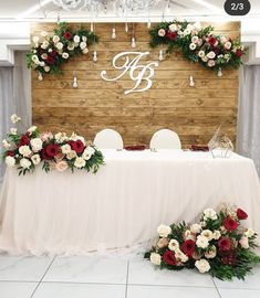 the table is set up with flowers and greenery