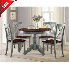 a dining room table with chairs and a vase