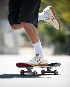 a man riding a skateboard down the middle of a street with his foot on it