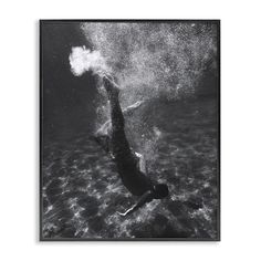 a black and white photo of a person swimming in the ocean with bubbles coming out of their face