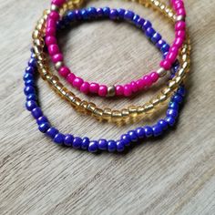 This bracelet set is inspired by the Magic Carpet, of Disney's Aladdin. The Magic Carpet bracelet set features glass seed beads in fuchsia, iridescent purple + translucent gold - fashioned after its embroidery. Size shown: 7 inches Strung on pre-stretched material. (Bracelet sold as a set.) Perfect for your next Disney trip or just for the thrill of it. The best part is you can wear all bracelets together or wear individually. The options are endless! Not a Disney fan? You can still tote this br Purple Bracelets With Tiny Beads For Festival, Gold Beaded Stretch Bracelet For Festivals, Purple Faceted Beads Bracelets For Festivals, Purple Faceted Beaded Bracelets For Festivals, Purple Faceted Beads Bracelet For Festivals, Iridescent Purple, Seed Bead Bracelet, Disney Aladdin, Disney Jewelry