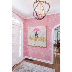 a room with pink wallpaper and an ornate chandelier hanging from the ceiling