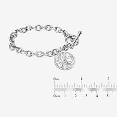 Wear this monogram charm bracelet as a constant reminder of the bond you share with someone special. Initials will appear exactly as entered. Must be three letters, center initial will be enlarged. Made in America.Metal: Rhodium-plated sterling silverClosure: ToggleDimensions: 7¼" long chainPendant Size: 20mmPersonalize: Up to 3 script initials. Initials will appear exactly as entered; center initial will be enlarged. Care: Wipe Clean Country of Origin: Made in USJewelry photos are enlarged to s Engraved Classic Charm Bracelet, Monogram Round Bracelet For Personalized Gift, Round Monogram Bracelet For Personalized Gift, Monogrammed Round Bracelet For Personalized Gift, Personalized Monogram Round Bracelet, Classic Engraved Charm Bracelet As Personalized Gift, Classic Engraved Charm Bracelet For Everyday, Classic Engraved Charm Bracelet For Personalized Gift, Engraved Stainless Steel Charm Bracelet