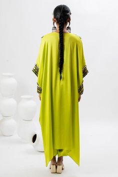 Green long kaftan kurta with hand embroidered ajrakh patch yoke in front. Comes with pant.
Components: 2
Pattern: Embroidered
Type Of Work: Ajrakh, Sequin, Zari, Thread
Neckline: Notched
Sleeve Type: Batwing
Fabric: Satin
Color: Green
Other Details: 
Note: Potli bag held by the model is not for sale
Occasion: Mehendi and Haldi - Aza Fashions Traditional Pattern Maxi Kaftan For Ceremonies, Traditional Pattern Maxi Kaftan For Festivals, Traditional Pattern Maxi Length Kaftan For Festivals, Traditional Patterned Festival Maxi Kaftan, Traditional Maxi Kaftan For Festivals, Traditional Drape Kaftan With Patterns, Festive Traditional Pattern Maxi Kaftan, Festive Traditional Maxi Kaftan, Festive Traditional Pattern Maxi Length Kaftan