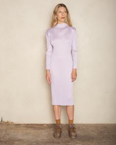 Turtleneck dress by Pleats Please Issey Miyake. A classic Pleats Please mid-length silhouette in radiant soft purple. Finished with an elegant lifted neckline and long sleeves. Signature vertical pleating with crisp and angular sleeve seams that can be folded completely flat for storage. 100% Polyester.Made in Japan. Pictured with Tapestry Low Tennis Shoes by Uma Wang. Purple Fitted Midi Dress, Purple Fitted Midi Length Dress, Fitted Purple Midi Dress, Lavender Long Sleeve Dress For Fall, Chic Purple Midi Dress For Winter, Purple Midi Dress For Spring Workwear, Spring Purple Midi Dress For Work, Purple Long Sleeve Dress For Winter, Chic Purple Midi Dress For Fall