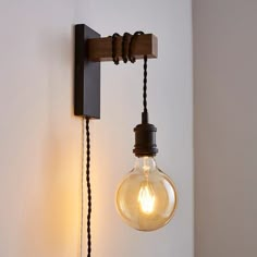 an old fashioned light bulb hanging from a wall