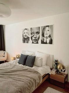 a bedroom with three black and white pictures on the wall