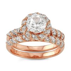 a rose gold ring set with an oval cut diamond in the center and two rows of diamonds on each band