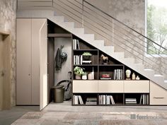 an open book shelf under the stairs in a room with carpeted flooring and beige walls