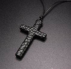 Introducing the Men's Black Wooden Cross Pendant Necklace - a timeless symbol of faith and style, crafted for modern men who appreciate minimalist designs. This cross necklace for men is meticulously handcrafted from high-quality black sandal wood, offering a sleek and bold look that suits any outfit. The pendant hangs from a durable chain, ensuring both comfort and durability for everyday wear. SPECIFICATIONS Material: Ebony Wood Color: Black Length: 1.97" / 5cm Width: 1.18" / 3cm About Ebony W Cross Jewelry Necklace, Wooden Watches For Men, 5 Year Anniversary Gift, Wooden Cross, Year Anniversary Gifts, Cross Pendant Necklace, Luxury Accessories, Wooden Jewelry, Wedding Rings For Women