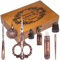 a wooden box with some scissors and other items