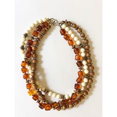 Gorgeous Vintage 1960s Three-Row Amber, Wooden and Ivory Beaded Necklace with silver accents. Choker length, sits beautifully against the neck. In excellent condition!! Retro Wooden Beads Jewelry, Vintage Beige Beaded Necklace, Vintage Adjustable Beaded Necklace With Silver Beads, Vintage Beaded Beige Necklace, Vintage Brown Double Strand Necklaces, Vintage Necklaces With Wooden Beads, Vintage Amber Beaded Necklaces, Vintage Adjustable Beige Necklace, Adjustable Vintage Beige Necklace