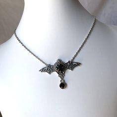 "This gothic vampire inspired necklace is made with an antiqued silver plated filigree bat and findings, accented with sparkling glass crystals in JET BLACK. Wingspan is 2 1/4\" wide and centerpiece is 1 1/2\" tall in the center. necklace isadjustable 15-18\" with a lobster clasp and chain extender in the back. If you would like a different length or stone color, please send us a message. Matching headpiece is available in our store." Silver Vampire Style Necklace, Gothic Nickel-free Necklace For Halloween, Gothic Nickel-free Necklaces For Halloween, Gothic Pendant Necklace For Halloween, Halloween Gothic Pendant Necklace, Nickel-free Gothic Necklaces For Party, Halloween Gothic Pendant Jewelry, Silver Vampire Style Metal Jewelry, Gothic Metal Necklace