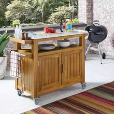 a kitchen island cart with plates and bowls on it