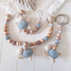 a crocheted necklace with two little birds on it, and some beads hanging from them