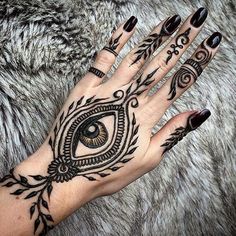 a woman's hand with an all seeing eye tattoo on it