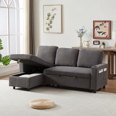 a living room scene with focus on the sectional sofa and footstool that is open