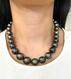 This beautiful black Tahitian pearl necklace ranges from 12 mm to 16.30 mm. The clasp has 114 round brilliant diamonds weighing 2.25 ct. The diamonds boast a color of E/F, are VS1 in clarity and are set in 18k white gold. A perfect piece for everyday wear! Luxury Tahitian Pearl Round Bead Necklace, Luxury Black Tahitian Pearl Necklaces, Luxury Tahitian Pearl Jewelry, Formal Black Tahitian Pearl Necklaces, Black High Luster Necklace For Formal Occasions, Formal High Luster Black Necklace, Formal Black High Luster Necklace, Formal Black High Luster Necklaces, Luxury Black Pearl Necklace With Round Beads