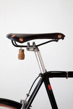 a close up of the handlebars on a bicycle with a white wall in the background