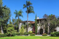 a house with palm trees in front of it