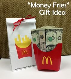 a bag with money in it sitting on a table next to a paper bag that says money fries gift idea