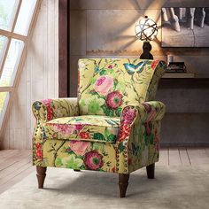 a floral chair in front of a window