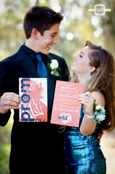 a man and woman are holding up signs