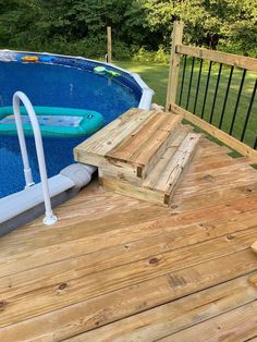 an above ground swimming pool with steps leading up to the deck and inflatable raft