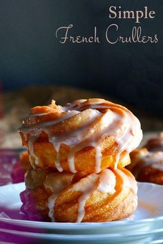 a stack of french crullers sitting on top of a blue and white plate