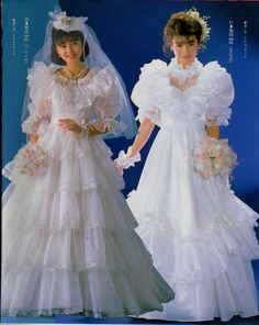 two brides in wedding gowns and veils