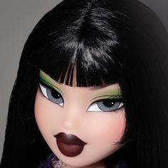 a doll with black hair and green eyes