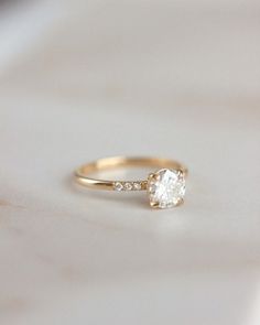 a gold ring with a single diamond on it