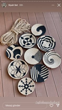 several black and white baskets sitting on top of a wooden floor next to a string