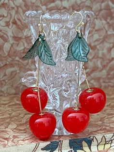 New condition cherry earrings. These drip 3". 2 cherries and leaves per earring. Cherries are about .50" wide. Please see all pictures.  Free shipping Cherry Dangle Earrings For Party, Cherry Color Dangle Earrings For Party, Party Cherry Earrings, Retro Red Earrings For Summer, Cherry Colored Earrings For Summer Party, Cherry Color Earrings For Summer Party, 1950 Dress, Cherry Earrings, Fruit Earrings