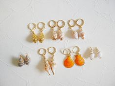 Natural tiny sea shell hoop earrings in 18k gold plated earrings. Shell size: about 20mm Metal component: 18k gold plated brass base Earrings hoop size : 14mm This listing is for a pair of earrings. ﹎﹎﹎﹎﹎﹎﹎﹎﹎﹎﹎﹎﹎﹎﹎﹎﹎﹎﹎﹎﹎﹎ ▲ Care instruction:  Please remove it before bathing or swimming.  Avoid your jewelry touching chemical such as hairsprays or perfumes.  Using soft cloth to clean your jewelry every time after wearing it, and store it in a dry and cool place. ▲ Gift packaging:  All products will be packed in a lovely gift bag with free of charge. There is no price tag or receipt so that you can send it as a gift directly. If you want to add a note card, please feel free to tell me. ▲ Processing time:  3-5 working days after receiving the payment. ▲ Shipping:  For standard shipping there i Gold Small Hoop Jewelry For The Beach, Gold Shell Earrings For Summer, Gold 14k Gold Filled Earrings For Beach, Gold Shell Earrings With Ear Wire As Gift, Gold Shell Earrings With Ear Wire For Gift, Gold Small Hoop Earrings For The Beach, Gold Shell Ear Wire Gift, Gold Dangle Shell Earrings For Summer, Handmade Gold Shell Hoop Earrings