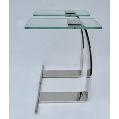 a glass table with metal legs and a shelf on one side that holds a cell phone