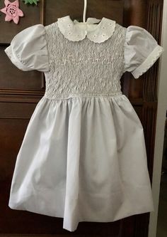 VTG POLLY FLINDERS HAND SMOCKED GIRLS DRESS SZ. 4 LIGHT GREY WHITE ACCENT UNWORN Tiny Pink Flowers, Polly Flinders Dresses, Girls Smocked Dresses, Hand Smock, White Accents, Girl Baby, Girls Dress, Vintage 1970s