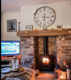 a living room filled with furniture and a large clock on the wall above a fireplace