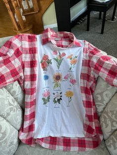 a red and white checkered shirt sitting on top of a couch